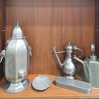All five pewter items displayed on wooden shelf