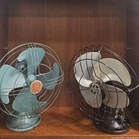 Both vintage GE table fans side by side showing overall condition