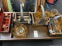 Overview of the wood baskets, stemware glasses, and an amber glass ashtray on a wooden table surface
