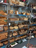 Photo of the full 6-tier metal shelving unit filled with baskets and miscellaneous items to show size and shelves.