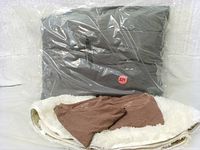 Bedroom rug, blanket, and king size pillows in packaging