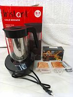 Photo of Instant Cold Brewer with box and lighting accessories including remote