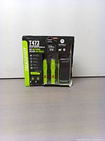 Front view of packaged three-pack Motorola T473 radios in black and green with branding and key feature highlights visible