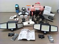 Full lot overview showing all items including pet dryer, solar lights, stud finder, power outlets, and other home improvement items.