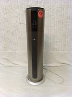 Front view showing cylindrical humidifier with silver body and black display panel with icons and logo.