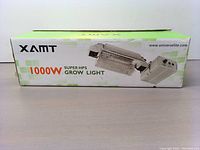 Boxed XAMT 1000W Super HPS Grow Light showing brand and model details on packaging.