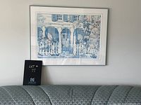 Framed print by Elizabeth Berry hanging on wall above couch, showing the entire artwork and part of room for scale.