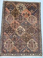 Front full view of hand knotted Bakhtiar Persian wool rug showing geometric panel design and muted colors.