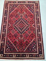 Full front view of rug laid flat showing overall geometric design and central medallion