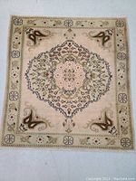 Full view of the Persian Kashan wool rug laid flat showing central medallion and border pattern in light green and beige tones.