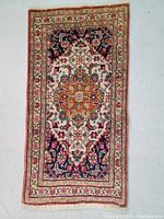 Full view of Persian Tabriz wool rug, displaying central medallion and floral motifs, fringe visible on ends.