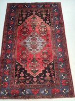 Full view of rug showing central geometric medallion and border pattern.