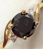 Front view showing central black diamond and right pink diamond accent