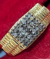 Close-up photo of the silver diamond cluster ring showing rectangular diamond setting and ribbed band design