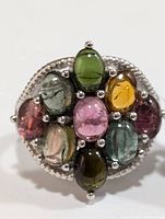 Top view showing nine oval cabochon tourmaline stones in assorted colors set in silver ring