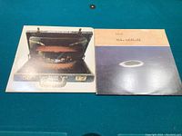 Photo showing two LP albums side by side on a green surface: Downchild's "Ready to Go" on the left and Mike Oldfield's "Islands" on the right.