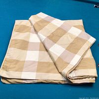 Folded king size duvet cover showing beige and white large checkered pattern.