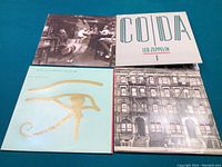 Top-down photo of four vinyl record album covers: Physical Graffiti and In Through the Out Door by Led Zeppelin; Coda by Led Zeppelin; Eye in the Sky by The Alan Parsons Project.