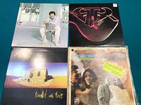 Photo showing five vinyl LP record covers including Lionel Richie, GTR, Midnight Oil Diesel and Dust, Ike and Tina Turner River Deep Mountain High, and one additional album with a dark cover.