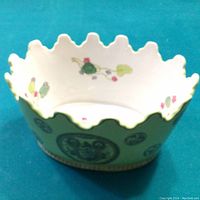 Oblique top-side view showing the scalloped rim and interior floral decoration of the jardinaire vase.