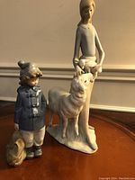 Photo of both porcelain figurines together showing scale and overall appearance.