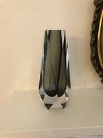 Front view of vase showing faceted clear exterior and smoke gray interior