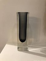 Front view of rectangular faceted art glass vase showing smoke gray interior with clear outer glass layer.