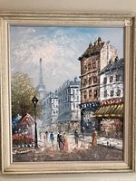 Full front view of the framed oil painting depicting a Paris street scene with Eiffel Tower in the background, showing the overall artwork and frame.