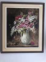 Frontal photo of the large oil painting showing a still life with flowers in a vase within original frame, label visible on frame corner.