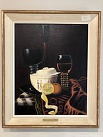 Full view of the framed oil painting showing the still life composition in deep color tones.