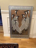 Framed and matted poster by Tom Taylor titled 'Nature and The Artist.' Depicts cranes in stylized graphic style with muted color palette. Poster is large, 39 inches by 24 inches, under glass with metal frame.