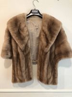 Front view of vintage woman's Lunaraine mink stole hanging on a hanger, showing full front fur and shawl collar design
