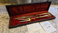 Full view of the antique silver and 24K gold carving set in original box with red satin lining and velvet cushioning.