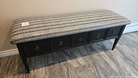 Full view of bench showing upholstery, base and drawer fronts