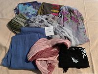 Full collection of scarves in varying colors and patterns suggesting different fabrics and sizes.