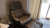 Front angle view of recliner with ottoman showing overall style and condition