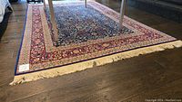 Full view of rug under table showing overall pattern and color scheme