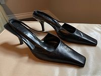 Angled front view of both shoes showing pointed toes and slingback profile