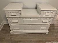Full front view of the white painted East Lake style dresser showing two small upper drawers and two large lower drawers with decorative carved detailing.