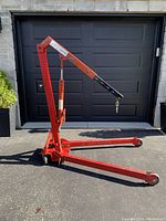 Crane in fully extended position showing legs spread and boom raised