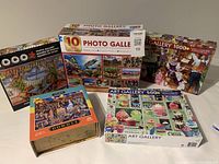 Image showing five puzzles including Dowdle 500 piece and Photo Gallery 1000, 1500 piece puzzles with various scenes