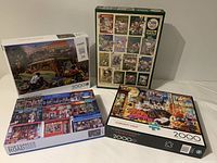 Four boxed puzzles stacked and arranged showing front and back artwork, one box front shows a man with vintage car, two other boxes show urban streetscape and shop interior, one box back shows multiple puzzle images collage
