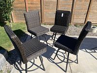 Four chairs arranged outdoors on patio, diagonal view
