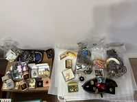 Overhead view of boxes, baggies and loose pieces showing rings, bracelets and earrings