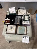 Overview of all eight jewelry pieces displayed in boxes