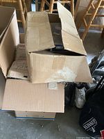Two cardboard boxes stacked on garage floor