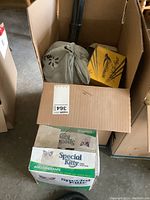 Two cardboard boxes in a garage setting.