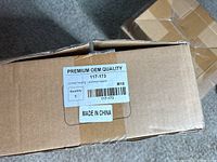Box labeled Premium OEM Quality, model 117-173, Oil filter housing support, made in China