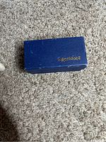 Blue box with gold ExxonMobil logo on lid.