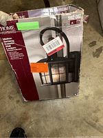 View of original packaging box, with some wear and tear, showing the product and brand name.